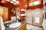 The red bathroom features a tub/shower combo